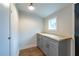 Laundry room featuring gray cabinetry, butcher block countertops and wood-look vinyl flooring at 973 Parsons Sw St, Atlanta, GA 30314