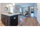 Open-concept living room featuring hardwood floors, island with pendant lighting, and stylish decor at 973 Parsons Sw St, Atlanta, GA 30314