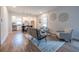 Cozy living room featuring hardwood floors, contemporary furniture, and an open layout leading to the kitchen at 973 Parsons Sw St, Atlanta, GA 30314