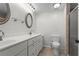 Bright bathroom with a double sink vanity, modern fixtures, a walk-in shower, and tile flooring at 1833 Lost Mountain Rd, Powder Springs, GA 30127