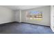 This bedroom offers natural light from two windows and ample space, complete with neutral walls and carpet flooring at 1833 Lost Mountain Rd, Powder Springs, GA 30127