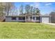 Charming one-story home with a well-maintained lawn and attached garage, perfect for suburban living at 1833 Lost Mountain Rd, Powder Springs, GA 30127