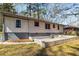 View of backyard patio area with brick retaining wall and whitewashed brick home at 2462 Macon Sw Dr, Atlanta, GA 30315