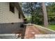 View of the backyard patio area with brick retaining wall and whitewashed brick home at 2462 Macon Sw Dr, Atlanta, GA 30315