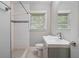 Bright bath with subway tile in shower, modern sink, and window with privacy blinds at 2462 Macon Sw Dr, Atlanta, GA 30315