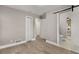 Bedroom with hardwood flooring, double closets, access to bathroom with sliding barn door at 2462 Macon Sw Dr, Atlanta, GA 30315