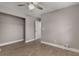 Bedroom with hardwood flooring, ceiling fan, closet with shelving, and neutral walls at 2462 Macon Sw Dr, Atlanta, GA 30315