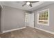 Bedroom with hardwood flooring, open door to another bedroom, and ceiling fan at 2462 Macon Sw Dr, Atlanta, GA 30315