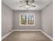 Bedroom featuring ceiling fan, neutral walls, hardwood floors, and window with natural light at 2462 Macon Sw Dr, Atlanta, GA 30315