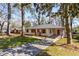Charming single-story home with a bright red door, brick accents, and mature trees in a well-manicured lawn at 2462 Macon Sw Dr, Atlanta, GA 30315