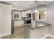 Cozy kitchen with granite countertops, stainless steel appliances, white cabinets, and modern pendant lighting at 2462 Macon Sw Dr, Atlanta, GA 30315