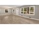 Bright living room showcasing large windows, neutral paint, wood floors, and ample natural light at 2462 Macon Sw Dr, Atlanta, GA 30315