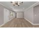 Spacious open-concept living room with wood flooring, large windows, and neutral walls, perfect for entertaining at 2462 Macon Sw Dr, Atlanta, GA 30315