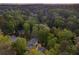 Lush greenery surrounds an impressive house with a sparkling pool, in an attractive overhead view at 2672 Langland Ne Ct, Atlanta, GA 30345