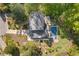 Aerial view showcasing an estate property with a pool, meticulously landscaped grounds, and mature trees at 2672 Langland Ne Ct, Atlanta, GA 30345
