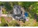 Aerial view showcasing a landscaped estate property with a pool, manicured lawns, and mature trees at 2672 Langland Ne Ct, Atlanta, GA 30345