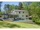 Expansive backyard featuring a manicured lawn, screened in porch, patio, and a pool at 2672 Langland Ne Ct, Atlanta, GA 30345