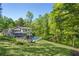 Expansive backyard with lush lawn, mature trees, and sparkling pool, creating a serene and private retreat at 2672 Langland Ne Ct, Atlanta, GA 30345