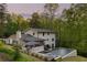 A large pool and hot tub are surrounded by a patio and lush green trees at 2672 Langland Ne Ct, Atlanta, GA 30345
