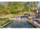 Backyard pool area featuring a modern pool, hot tub, and lounge chairs at 2672 Langland Ne Ct, Atlanta, GA 30345