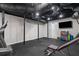 Finished basement with black ceilings, rubber flooring, exercise equipment, and white walls at 2672 Langland Ne Ct, Atlanta, GA 30345