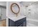 Stylish bathroom features marbled tile, a woven mirror, and a sleek vanity at 2672 Langland Ne Ct, Atlanta, GA 30345