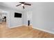Bedroom featuring hardwood floors with a mounted TV and two doorways leading to other rooms at 2672 Langland Ne Ct, Atlanta, GA 30345