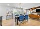 Dining area includes a table with blue chairs, contemporary lighting, and an open view into the living room at 2672 Langland Ne Ct, Atlanta, GA 30345