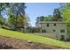 A spacious backyard, featuring a manicured lawn, covered patio, and an inviting swimming pool at 2672 Langland Ne Ct, Atlanta, GA 30345