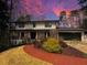 Inviting two-story home featuring a brick walkway, covered porch, and attached two car garage at 2672 Langland Ne Ct, Atlanta, GA 30345