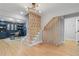 Inviting foyer with hardwood floors, custom staircase detail, and view into a stylish office space at 2672 Langland Ne Ct, Atlanta, GA 30345