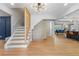 Bright foyer featuring hardwood floors, decorative staircase, and an open floor plan to the kitchen and dining areas at 2672 Langland Ne Ct, Atlanta, GA 30345