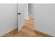 Hallway with hardwood floors, neutral walls, and a white door with black hardware at 2672 Langland Ne Ct, Atlanta, GA 30345