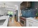 Modern kitchen with an island, stainless steel appliances, and a stylish backsplash at 2672 Langland Ne Ct, Atlanta, GA 30345