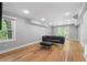 Finished room with hardwood floors, neutral walls, modern lighting, a large window, and french doors to the exterior at 2672 Langland Ne Ct, Atlanta, GA 30345