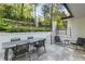 Outdoor patio featuring a dining table with seating, landscaped garden, and access steps at 2672 Langland Ne Ct, Atlanta, GA 30345