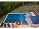 Aerial view showcasing the sparkling backyard pool, connected hot tub, and surrounding natural, wooded scenery at 2672 Langland Ne Ct, Atlanta, GA 30345