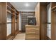 Spacious walk-in closet with custom wood shelving, drawers, and ample storage space for clothing and accessories at 2672 Langland Ne Ct, Atlanta, GA 30345