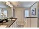 Stylish bathroom featuring double sinks, a soaking tub, and a glass-enclosed shower at 2698 Ne Almand Ln, Conyers, GA 30013