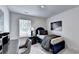 Cozy bedroom with a twin bed, desk, and comfortable seating, perfect for relaxation and study at 2698 Ne Almand Ln, Conyers, GA 30013