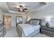 Cozy bedroom with a tray ceiling, neutral gray tones, and a decorative mirror at 2698 Ne Almand Ln, Conyers, GA 30013