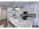 Bright kitchen featuring stainless steel appliances, white cabinets and an island with seating at 2698 Ne Almand Ln, Conyers, GA 30013