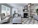 Open-concept living room with modern furniture, fireplace, large windows and neutral decor at 2698 Ne Almand Ln, Conyers, GA 30013