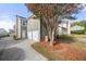 Rear view of the home featuring a two-car garage and long driveway at 3660 Lake Pass Ln, Suwanee, GA 30024