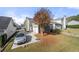 Rear view of the home featuring a two-car garage, spacious backyard, and long driveway at 3660 Lake Pass Ln, Suwanee, GA 30024