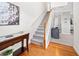 Welcoming entryway with hardwood floors and staircase with wood banister at 3660 Lake Pass Ln, Suwanee, GA 30024