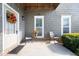 Welcoming front porch with cozy seating, decorative wreath, and charming curb appeal at 3660 Lake Pass Ln, Suwanee, GA 30024