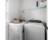 Practical laundry room with modern washer and dryer units, shelving, and natural light for efficient chores at 3660 Lake Pass Ln, Suwanee, GA 30024