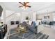 Spacious living room with a large sectional, fireplace, and open view to the dining area for easy entertaining at 3660 Lake Pass Ln, Suwanee, GA 30024