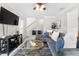 Open living room features a comfortable sectional sofa, modern ceiling fan, and staircase access at 3660 Lake Pass Ln, Suwanee, GA 30024